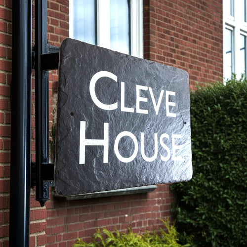 Slate sign with 'CLEVE HOUSE' in bright white lettering on a brick building. Town house signs.