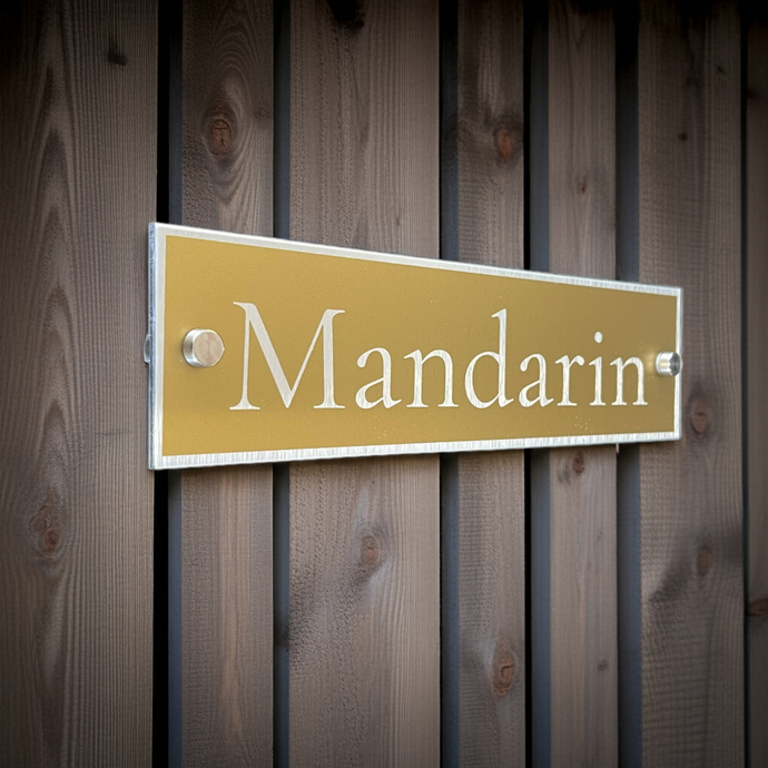 Gold sign with 'Mandarin' text on a wooden background. Modern and stands out as stylish.