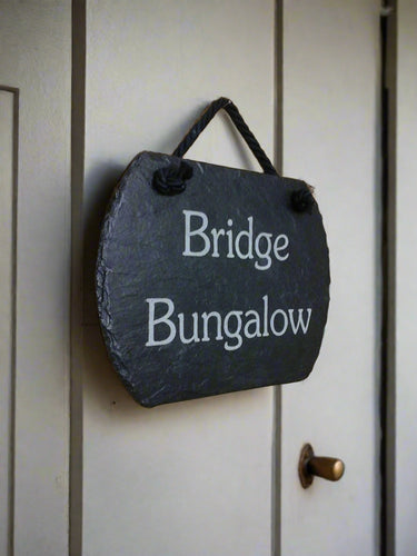 Slate sign with 'Bridge Bungalow' text on a hanging rope and rounded edges