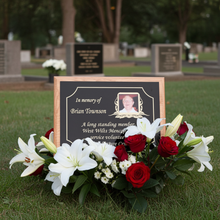 Memorial plaque with flowers in a cemetery