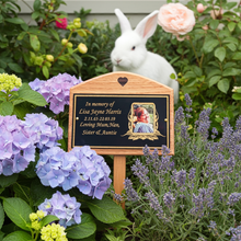 Memorial plaque for Lisa Jayne Harris in a garden with flowers and a rabbit.