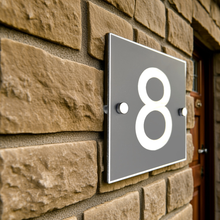 House number '8' on a stone wall