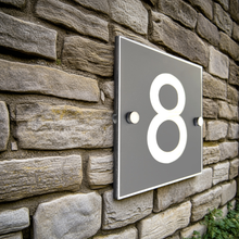House number '8' on a stone wall