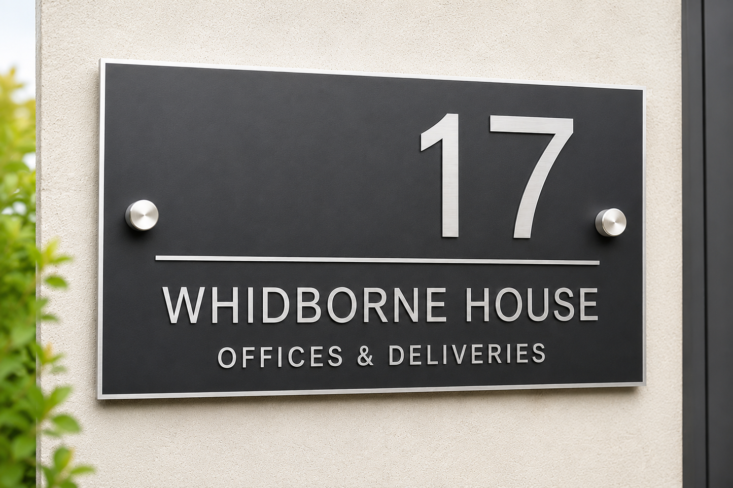 A black rectangular house number sign mounted on a beige exterior wall, with silver screws and white text reading “17 WHIDBORNE HOUSE OFFICES & DELIVERIES.”.