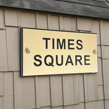 Sign on a wall with 'TIMES SQUARE' text