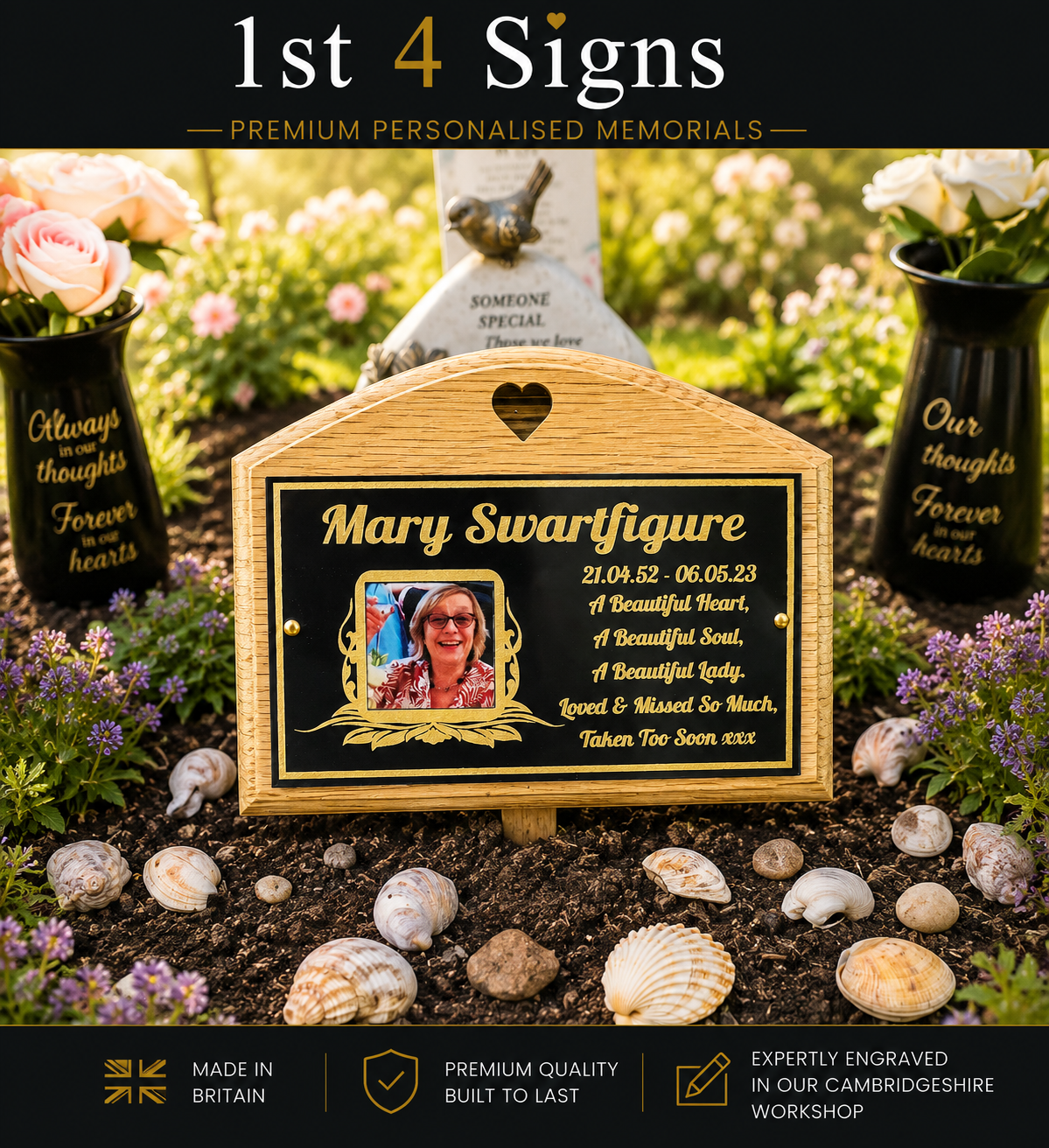 A personalized wooden grave marker with a black plaque, gold lettering, and a small portrait photo, displayed outdoors on a bed of seashells with flowers and other memorial markers in the background. The top banner reads '1st 4 Signs' and the bottom banner includes trust badges and text about being made in Britain and expertly engraved.
