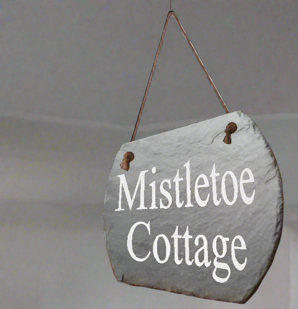 Slate sign with 'Mistletoe Cottage' in Times Roman font on a hanging rope