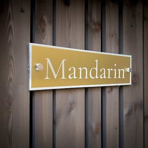 Gold sign with 'Mandarin' text on a wooden background. Modern and stands out as stylish.