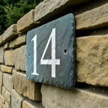 House number '14' on a stone wall