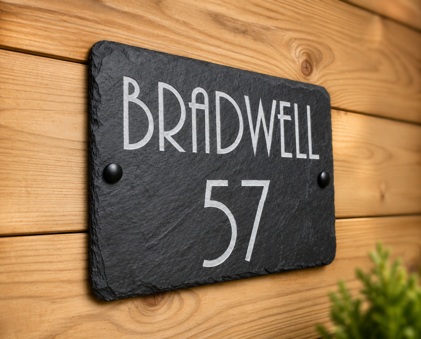 Handcrafted natural slate home address marker personalised with a laser etched house name and number, featuring authentic riven edges and a durable finish for elegant outdoor property identification.