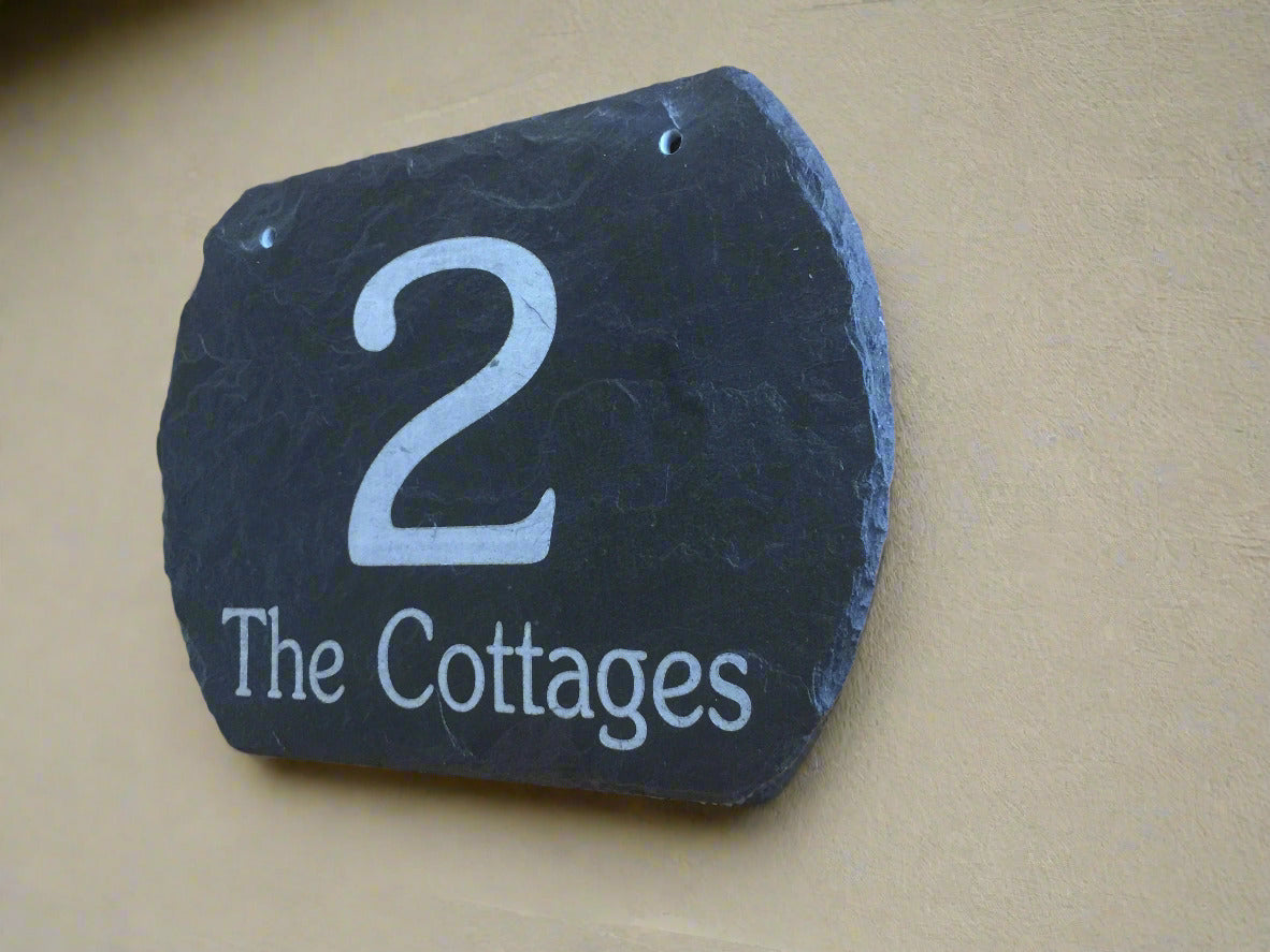 Slate house number sign with '2 The Cottages' with shaped curved edges