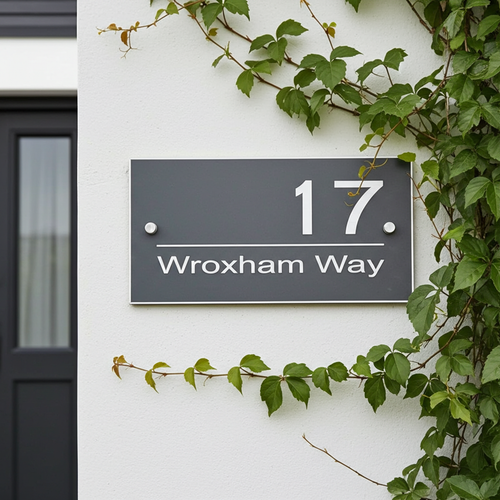 House number sign '17 Wroxham Way' on a white wall with green ivy