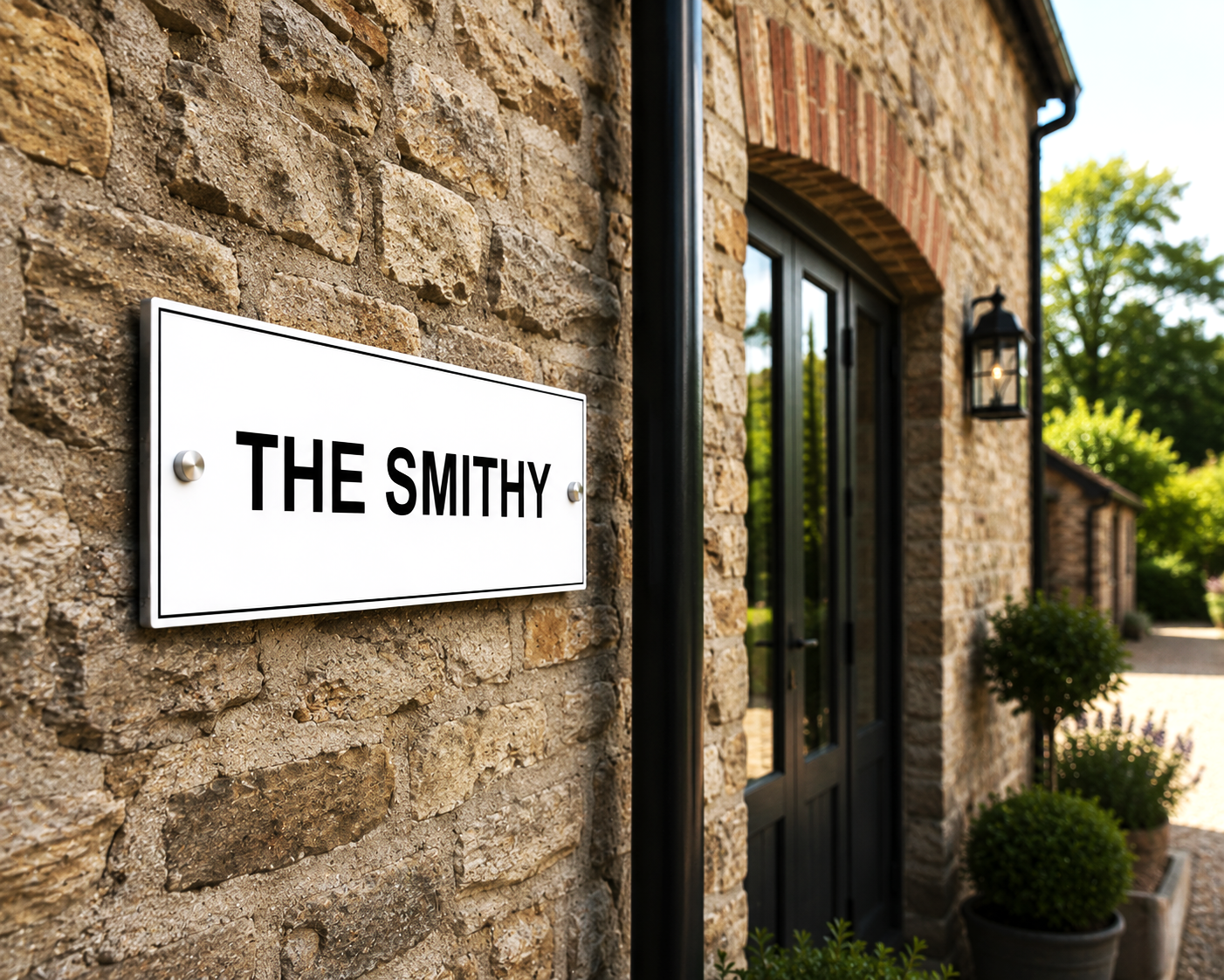 Personalised white aluminium house sign with black lettering, contemporary matt metal house plaque with hidden floating or visible stand-off fixing options for modern homes.