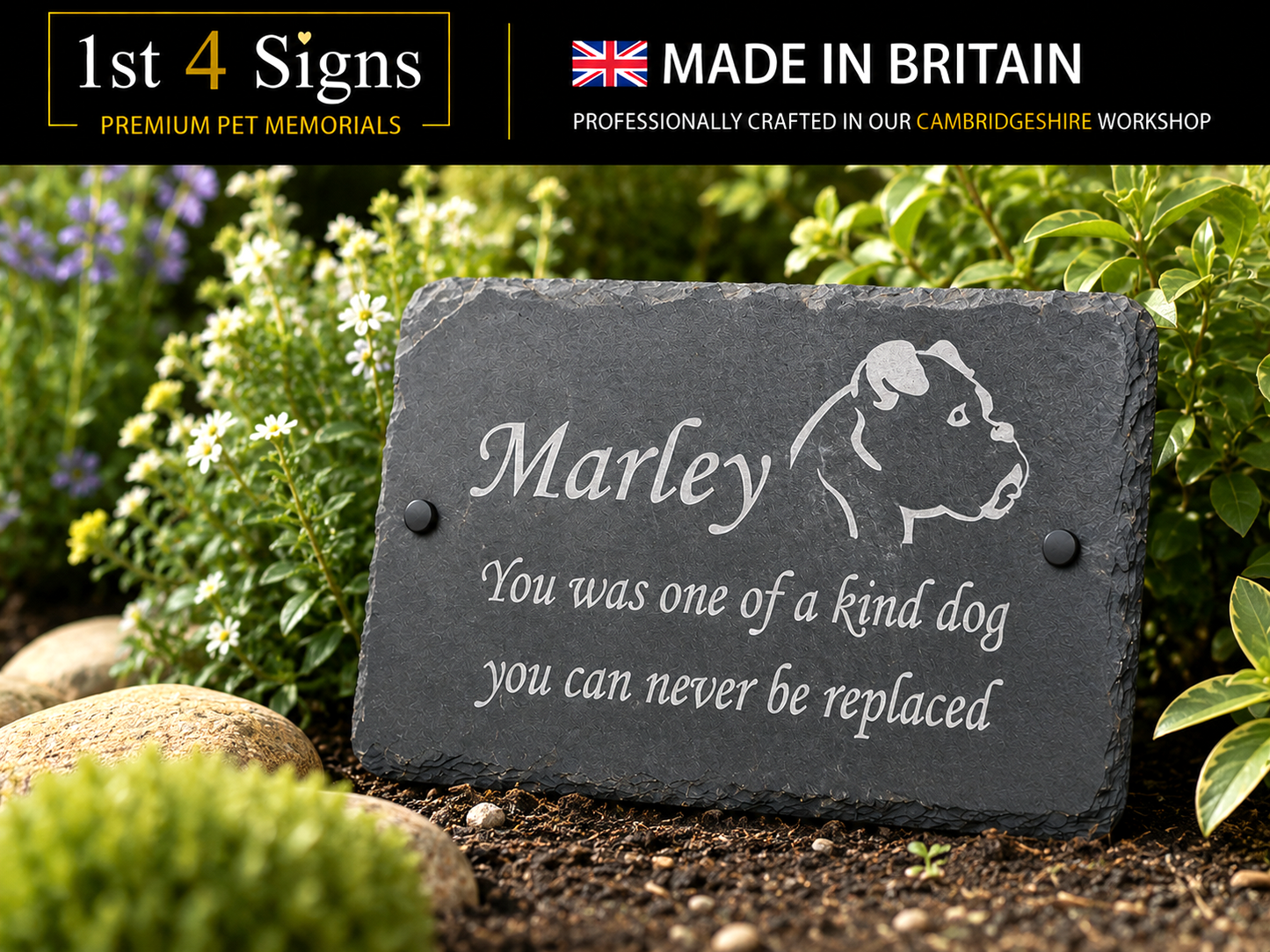 Personalized dark gray slate pet memorial garden plaque engraved with the name 'Marley' and a dog silhouette, placed outdoors among green plants and flowers. A black banner at the top reads '1st 4 Signs' and 'MADE IN BRITAIN'.
