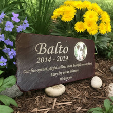 Memorial plaque for Balto with floral arrangement in the background. Commemorative memorials for pets.