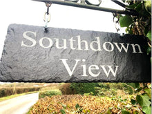 Slate sign with 'Southdown View' text hanging outdoors.