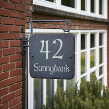 House number sign with '42 Sunnybank' on a brick building.