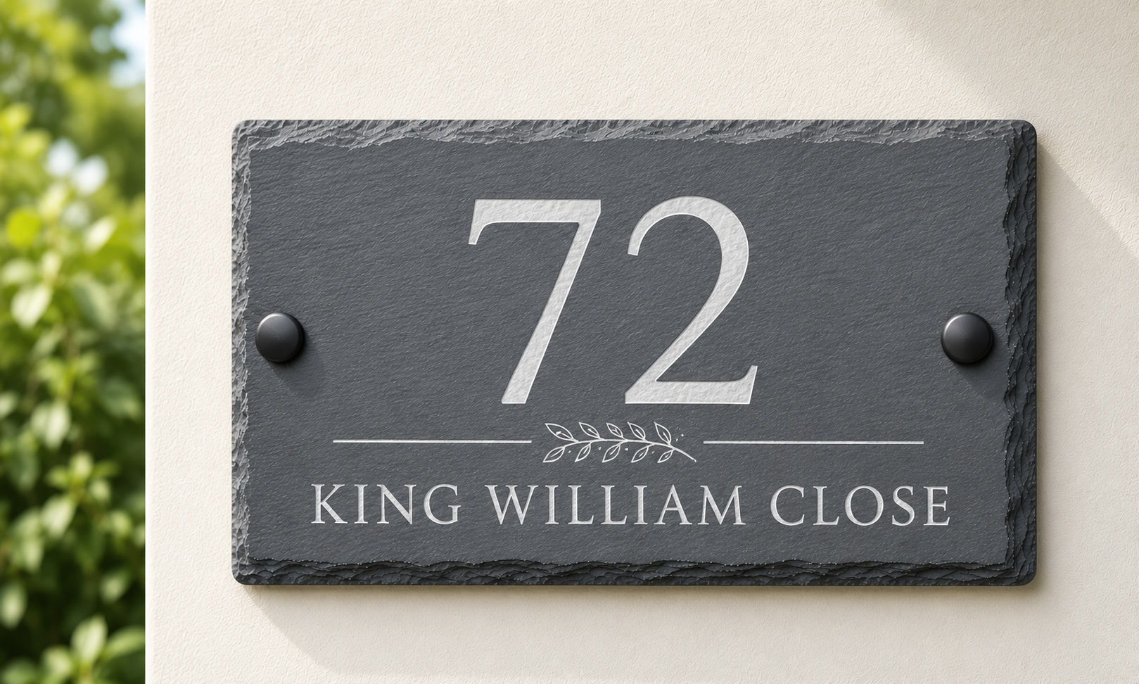 A rectangular dark slate house number plaque mounted on a beige wall, with the number 72 and the text KING WILLIAM CLOSE in white lettering.