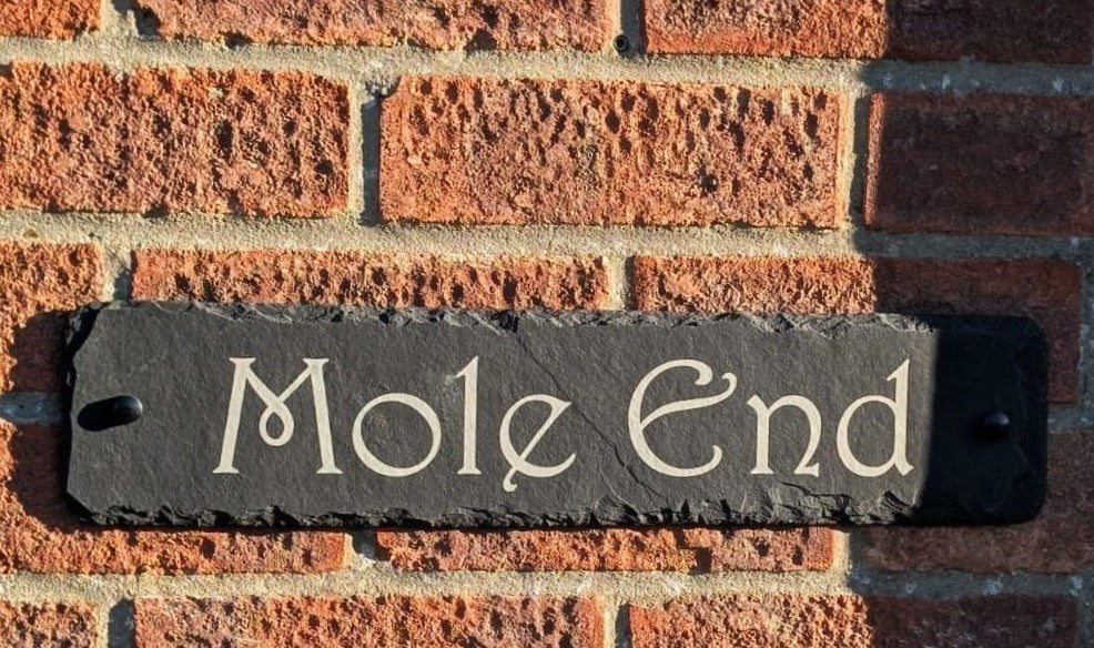 Slate wall sign custom-made to read "Mole End" in Harrington font.