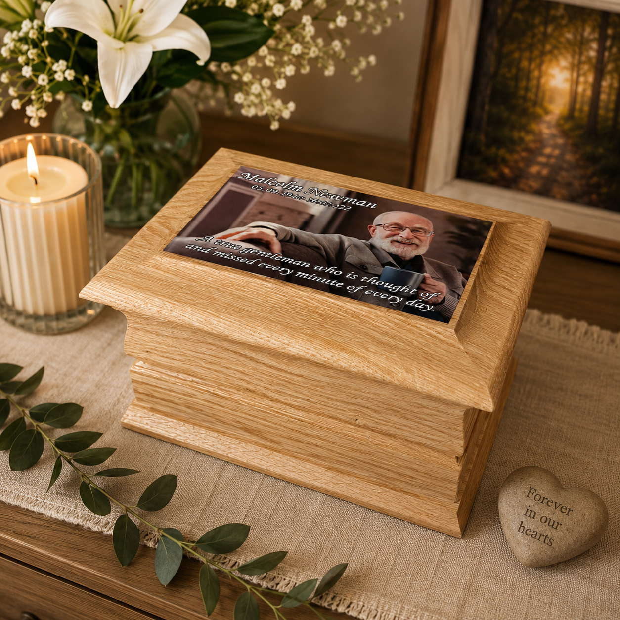 Personalised solid oak photo ashes casket with full-colour memorial photograph and wording printed on the top, featuring decorative curved edges. Handmade in Britain.