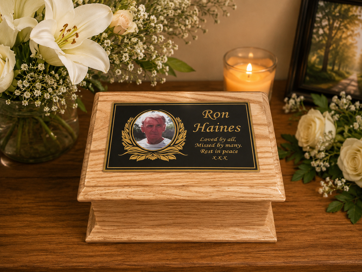 Personalised solid oak ashes casket with Gold memorial plaque, curved decorative edges and bespoke wording, handcrafted in Britain.